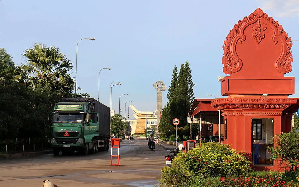 The Cambodia welcome arch at Bavet checkpoint, with Moc Bai border gate in the distance